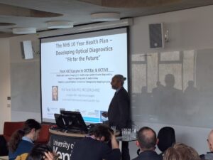 a speaker and a presentation slide behind him